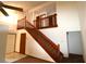 View of a carpeted staircase with wooden railings in a home with a vaulted ceiling at 4214 Longfellow Dr, Plant City, FL 33566