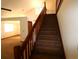 Carpeted staircase with wood railing and trim leads to the upper level at 4214 Longfellow Dr, Plant City, FL 33566