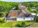 Aerial view of the house highlighting the backyard screened-in lanai, roof, and mature landscaping at 4227 Sandy Shores Dr, Lutz, FL 33558