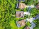 An aerial view shows houses in a neighborhood surrounded by trees, offering a serene setting at 4227 Sandy Shores Dr, Lutz, FL 33558