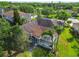 Aerial view of the house highlighting the backyard screened-in lanai, roof, and mature landscaping at 4227 Sandy Shores Dr, Lutz, FL 33558