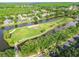 An aerial view highlights a unique golf course nestled between waterways and residential areas, offering scenic views at 4227 Sandy Shores Dr, Lutz, FL 33558