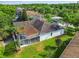 Aerial view of the house highlighting the backyard screened-in lanai, roof, and mature landscaping at 4227 Sandy Shores Dr, Lutz, FL 33558