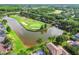 Beautiful aerial view of an island golf green surrounded by a lake in a residential community at 4227 Sandy Shores Dr, Lutz, FL 33558