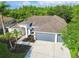 Aerial view of a house with mature landscaping and a well manicured lawn at 4227 Sandy Shores Dr, Lutz, FL 33558