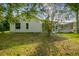 A view of the backyard showing the home's screened in patio at 4227 Sandy Shores Dr, Lutz, FL 33558
