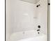 Bright bathroom featuring a tub and shower combination with black fixtures and sleek white tiling at 4227 Sandy Shores Dr, Lutz, FL 33558