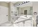 Bright bathroom featuring double vanity with white cabinets, quartz counters, and modern black fixtures at 4227 Sandy Shores Dr, Lutz, FL 33558