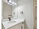 Bright bathroom with a modern sink, black faucet, and a large mirror, creating a clean and contemporary feel at 4227 Sandy Shores Dr, Lutz, FL 33558