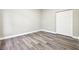 Cozy bedroom showcasing stylish gray wood flooring and a spacious closet for ample storage at 4227 Sandy Shores Dr, Lutz, FL 33558