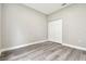 Neutral bedroom with gray wood floors and a closet provides a versatile space ready for personal touches at 4227 Sandy Shores Dr, Lutz, FL 33558