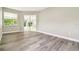 Bright bedroom with wood flooring and sliding glass doors leading to the outdoors at 4227 Sandy Shores Dr, Lutz, FL 33558