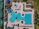 Aerial shot of a community pool with a separate lap pool, ' area, and a slide at 4227 Sandy Shores Dr, Lutz, FL 33558