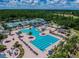 Aerial view of a large community pool and recreation area with tennis courts and playground at 4227 Sandy Shores Dr, Lutz, FL 33558