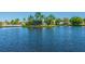 Water view of community sign at the entrance of a community with lush greenery at 4227 Sandy Shores Dr, Lutz, FL 33558