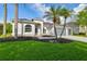 Charming single-story home with a well-manicured lawn and beautiful palm trees at 4227 Sandy Shores Dr, Lutz, FL 33558