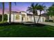 Charming home featuring a three-car garage, manicured lawn, and mature palm trees at 4227 Sandy Shores Dr, Lutz, FL 33558