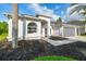 Beautifully landscaped home with a well-maintained lawn and a two-car garage at 4227 Sandy Shores Dr, Lutz, FL 33558
