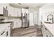 Modern kitchen featuring white cabinets, stainless steel appliances, and quartz countertops at 4227 Sandy Shores Dr, Lutz, FL 33558