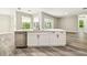 Beautiful kitchen island with stainless steel dishwasher, sleek countertops, and stylish hardware at 4227 Sandy Shores Dr, Lutz, FL 33558
