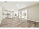 Open-concept living area showcasing modern flooring and an adjacent kitchen and outdoor patio at 4227 Sandy Shores Dr, Lutz, FL 33558