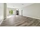 Bright open-concept living room with wood flooring and large windows at 4227 Sandy Shores Dr, Lutz, FL 33558