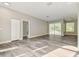 Spacious living area featuring wood-look flooring, ample natural light, and easy access to outdoor space at 4227 Sandy Shores Dr, Lutz, FL 33558