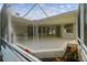 A screen-enclosed patio includes a built in bar and plenty of space for outdoor entertaining at 4227 Sandy Shores Dr, Lutz, FL 33558