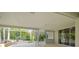 Covered outdoor patio with a built-in bar area and a serene view of the surrounding greenery at 4227 Sandy Shores Dr, Lutz, FL 33558