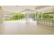Spacious outdoor patio featuring a bar, a white floor, an eating area, and a screened enclosure at 4227 Sandy Shores Dr, Lutz, FL 33558