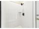 Contemporary shower featuring a sleek design with white tiled walls and modern matte black fixtures at 4227 Sandy Shores Dr, Lutz, FL 33558