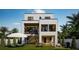This backyard has a covered lanai, outdoor dining area, lounge chairs, a grill and is surrounded by tropical foliage at 4322 26Th S Ave, Gulfport, FL 33711