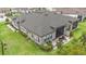 Aerial view of the home featuring a screened patio, manicured lawn, and paver patio with firepit at 4329 Barletta Ct, Wesley Chapel, FL 33543