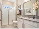 This bathroom features a single sink vanity and a glass enclosed shower at 4329 Barletta Ct, Wesley Chapel, FL 33543