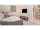 Neutral bedroom features a daybed, wall decor and a tv at 4329 Barletta Ct, Wesley Chapel, FL 33543