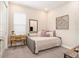 This neutral bedroom features a daybed, mirror, and unique wall art at 4329 Barletta Ct, Wesley Chapel, FL 33543