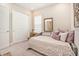 This neutral bedroom features a daybed, closet, mirror and window with blinds at 4329 Barletta Ct, Wesley Chapel, FL 33543
