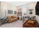 Eclectic bonus room with sofa, drum set, guitar and neon haircut sign at 4329 Barletta Ct, Wesley Chapel, FL 33543