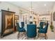 A dining room featuring a glass table with six chairs, and a decorative cabinet at 4329 Barletta Ct, Wesley Chapel, FL 33543