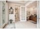 Elegant hallway with decorative mirror and glass doors leading to a well-lit office at 4329 Barletta Ct, Wesley Chapel, FL 33543