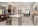 A modern kitchen with a breakfast bar overlooking a living area at 4329 Barletta Ct, Wesley Chapel, FL 33543