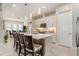 A bright eat-in kitchen with an island with seating, stainless appliances, and tile floors at 4329 Barletta Ct, Wesley Chapel, FL 33543
