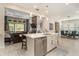 A modern kitchen overlooking the living area, featuring stainless appliances and a breakfast bar at 4329 Barletta Ct, Wesley Chapel, FL 33543