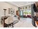 An open living room with high ceilings, a sectional sofa, and access to outdoor seating at 4329 Barletta Ct, Wesley Chapel, FL 33543