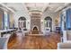 Elegant club lounge with hardwood floors, coffered ceilings, stone fireplace, and stylish furnishings at 4329 Barletta Ct, Wesley Chapel, FL 33543