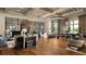 Elegant club lounge with hardwood floors, coffered ceilings, stone fireplace, bar and stylish furnishings at 4329 Barletta Ct, Wesley Chapel, FL 33543