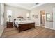This main bedroom features tray ceiling, wood-look tile flooring and ensuite bathroom at 4329 Barletta Ct, Wesley Chapel, FL 33543