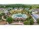 Aerial view of a luxurious community pool featuring palm trees, lounge chairs and manicured landscaping at 4329 Barletta Ct, Wesley Chapel, FL 33543