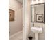 Stylish powder room showcasing a pedestal sink and elegant mirror at 4329 Barletta Ct, Wesley Chapel, FL 33543