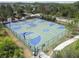 Aerial view of a community tennis and basketball court, surrounded by trees and lush greenery at 4329 Barletta Ct, Wesley Chapel, FL 33543